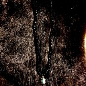 Black necklace with coral blue charm